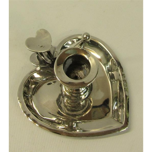 236 - A late Victorian chamber stick of heart shaped form, the finger ring with heart shaped thumb piece a... 