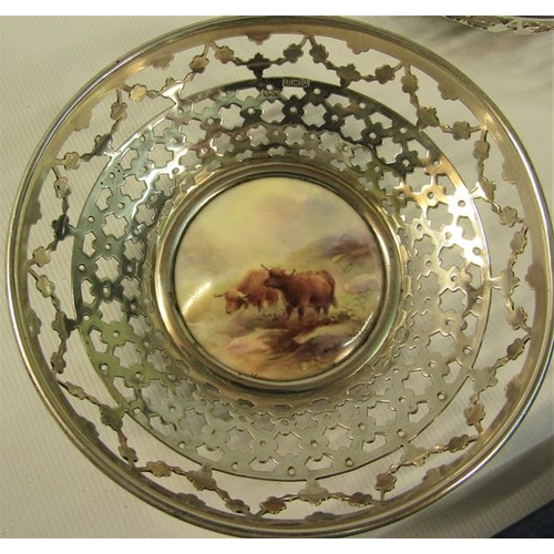 237 - A pair of circular silver bowls, pierced and with James Stinton Royal Worcester bases, both decorate... 