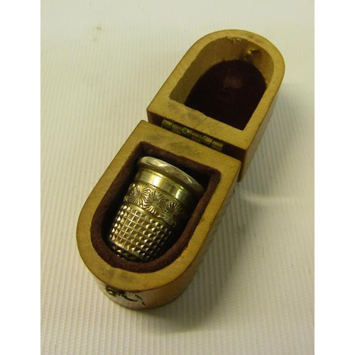 105 - A Mauchline Ware thimble case with a transfer the beach Sandgate, Kent and containing a silver thimb... 