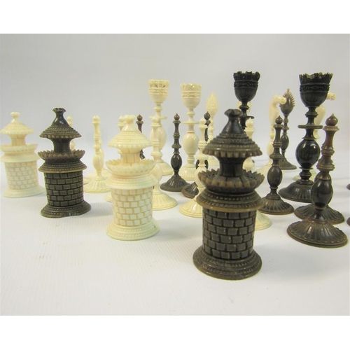 111 - A 19c Indian ivory and horn chess set, the Kings 9cms high - contained in a sandalwood lined box, th... 