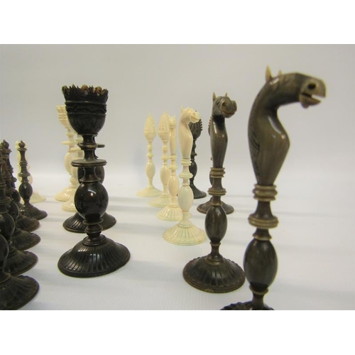 111 - A 19c Indian ivory and horn chess set, the Kings 9cms high - contained in a sandalwood lined box, th... 