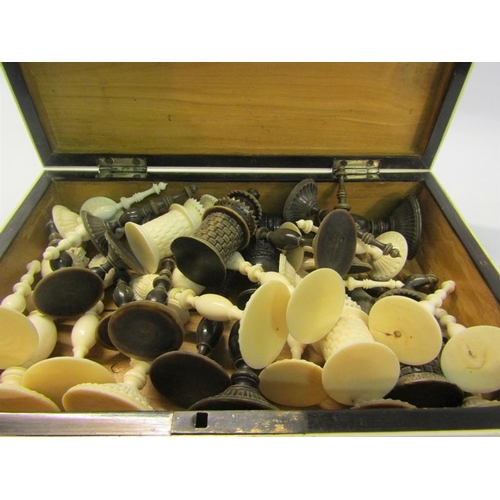 111 - A 19c Indian ivory and horn chess set, the Kings 9cms high - contained in a sandalwood lined box, th... 