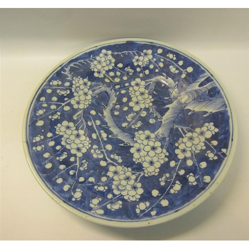 354 - A 19c Chinese blue and white circular dish decorated with Prunus blossom, 29cms dia.