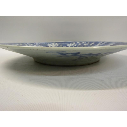 354 - A 19c Chinese blue and white circular dish decorated with Prunus blossom, 29cms dia.