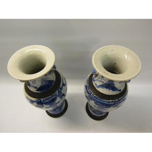 357 - A pair of early 19c Chinese baluster vase and covers, blue on white decorated ladies in veranda sett... 