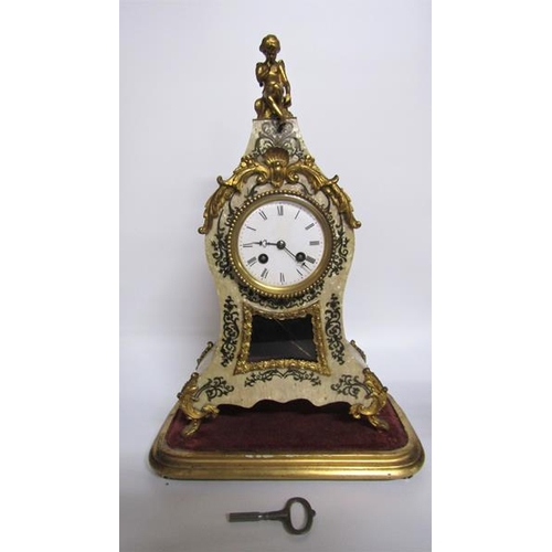 8 - A mid 19c French mantel clock the waisted case having a glazed pendulum aperture below the dial and ... 