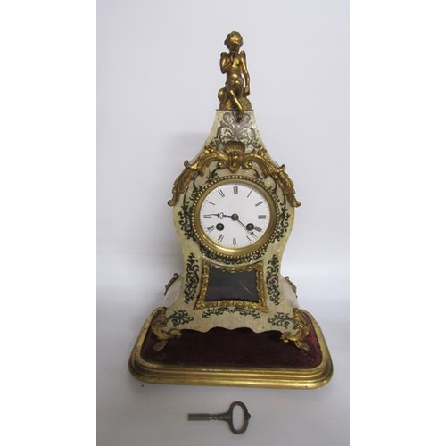 8 - A mid 19c French mantel clock the waisted case having a glazed pendulum aperture below the dial and ... 