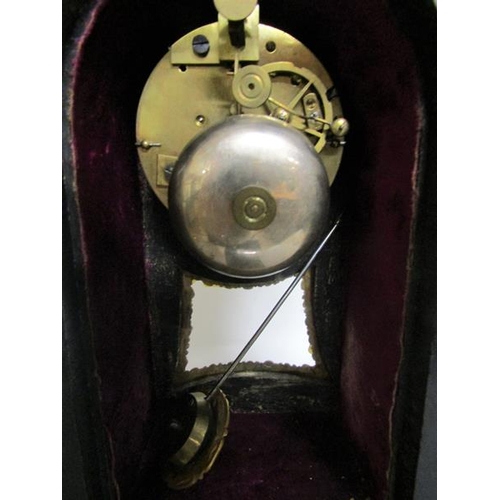 8 - A mid 19c French mantel clock the waisted case having a glazed pendulum aperture below the dial and ... 