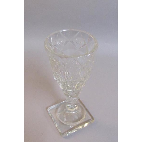 337 - A 19c square base wine glass with a diamond and circle cut bowl on a facet cut stem.  13cm h.