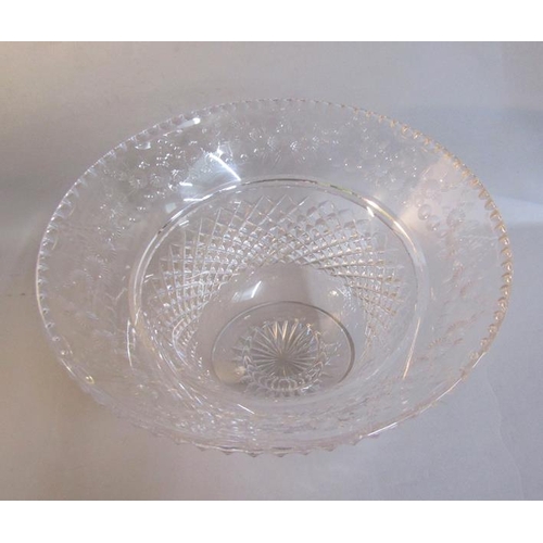 344 - A crystal centre bowl, diamond cut and wheel engraved around rim with garlands of flowers on a star ... 