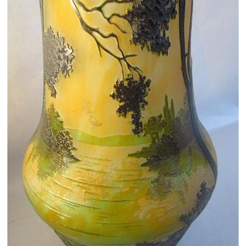 351 - A large French Daum Nancy cameo glass vase decorated with a landscape surrounded by trees in orange,... 