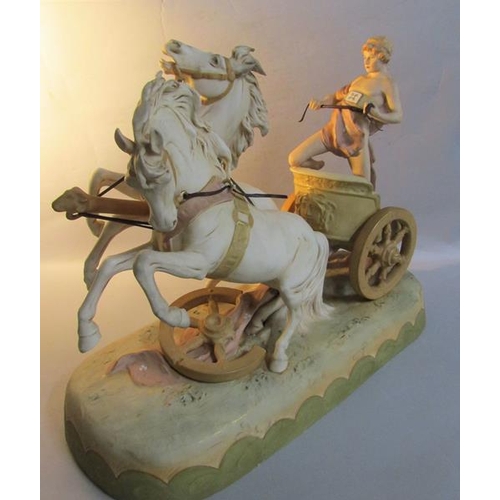 411 - A large late 19c Royal Dux figure group depicting a man riding a chariot drawn by two horses no. 169... 