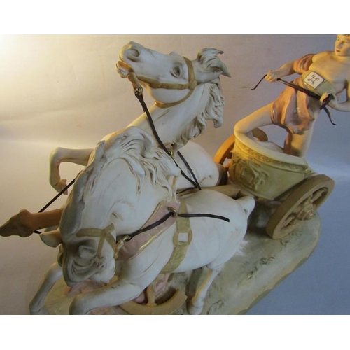 411 - A large late 19c Royal Dux figure group depicting a man riding a chariot drawn by two horses no. 169... 