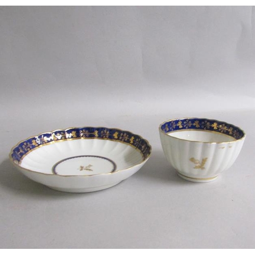 373 - A Worcester fluted tea bowl and saucer with blue and gilt border, gilt Thistle reserved in base.  Cr... 