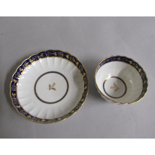 373 - A Worcester fluted tea bowl and saucer with blue and gilt border, gilt Thistle reserved in base.  Cr... 