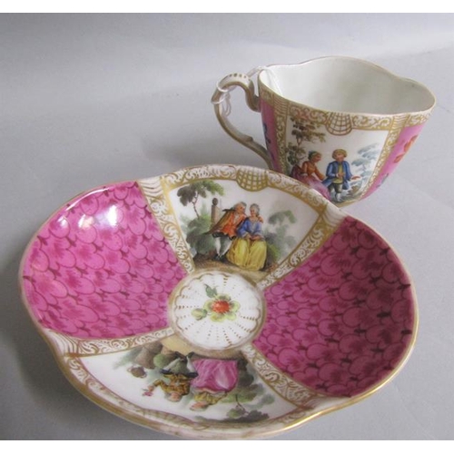 386 - A 19c Meissen cabinet cup and saucer painted with alternate panels of figures on pink scale ground, ... 