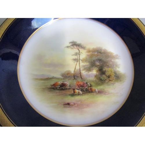 407 - A pair of Royal Worcester circular dishes by John Stinton, one with highland cattle in misty mountai... 