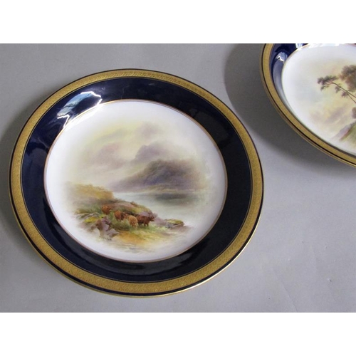 407 - A pair of Royal Worcester circular dishes by John Stinton, one with highland cattle in misty mountai... 