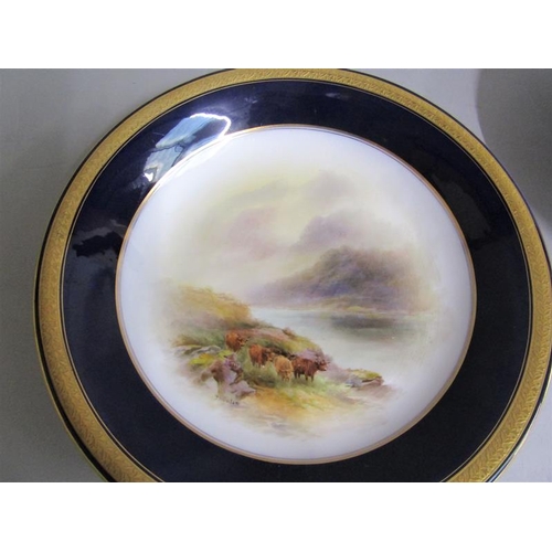 407 - A pair of Royal Worcester circular dishes by John Stinton, one with highland cattle in misty mountai... 