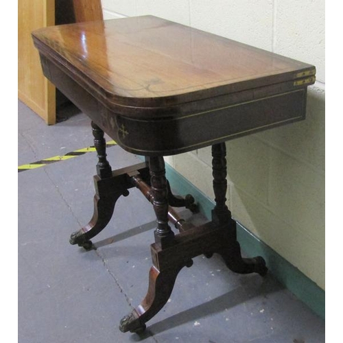 544 - A late Georgian figured mahogany fold over card table the table top with brass rail inlay cross band... 