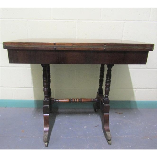 544 - A late Georgian figured mahogany fold over card table the table top with brass rail inlay cross band... 