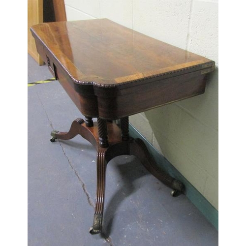 545 - A Regency rosewood fold over card table with brass rail inlay raised on a stretcher frame with ring ... 