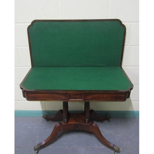 545 - A Regency rosewood fold over card table with brass rail inlay raised on a stretcher frame with ring ... 