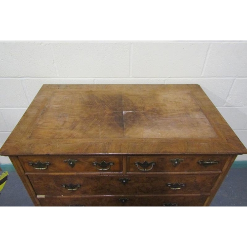 546 - An 18c figured walnut chest of two short and three long graduated drawers.  The top with wide cross ... 