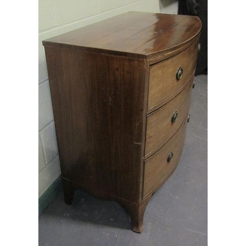 570 - A late Georgian mahogany bow front chest of three long graduated drawers with circular stamped brass... 