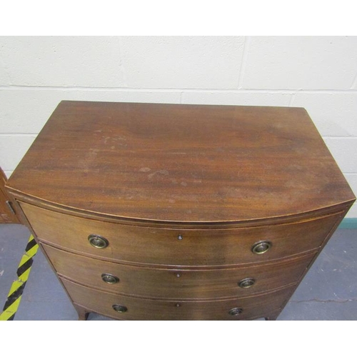 570 - A late Georgian mahogany bow front chest of three long graduated drawers with circular stamped brass... 