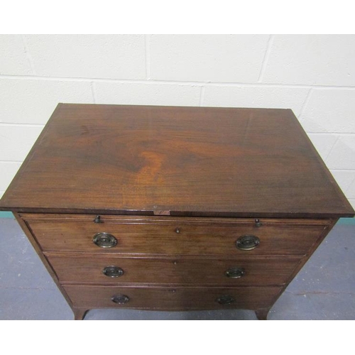 571 - A late Georgian mahogany chest of three long graduated drawers with a slide, supported on splayed le... 