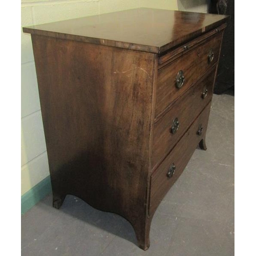 571 - A late Georgian mahogany chest of three long graduated drawers with a slide, supported on splayed le... 