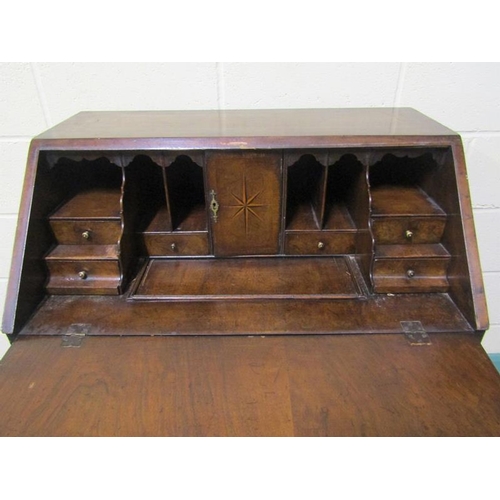 572 - A late Georgian mahogany bureau with fall front and fitted interior over three long drawers and one ... 