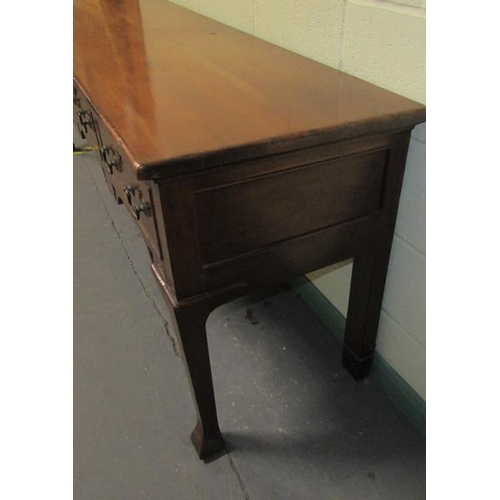 608 - An early 19c Cherrywood four drawer dresser base with fret cut apron supported on square carved tape... 