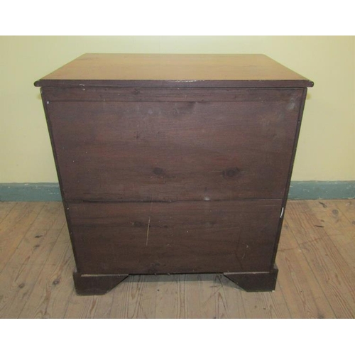 549 - A late Georgian mahogany chest of four long drawers with cut brass back plates and swing handles.  O... 