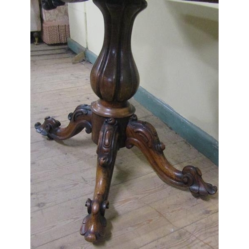 551 - A William IV rosewood fold over card table with scroll moulded frieze supported on a lobed baluster ... 