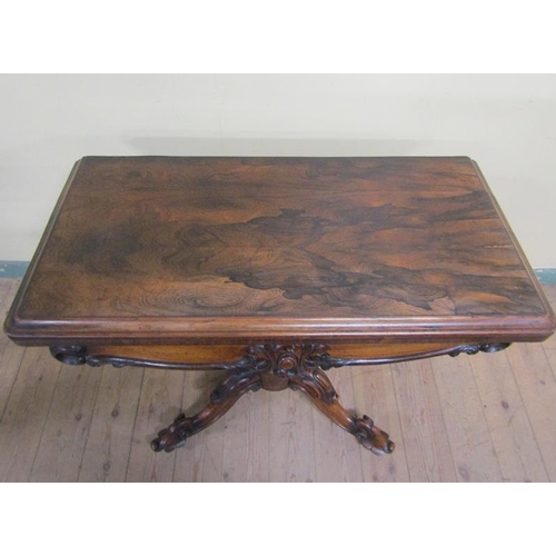 551 - A William IV rosewood fold over card table with scroll moulded frieze supported on a lobed baluster ... 