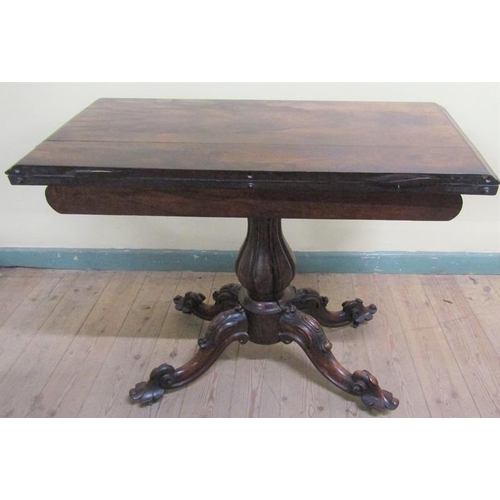 551 - A William IV rosewood fold over card table with scroll moulded frieze supported on a lobed baluster ... 