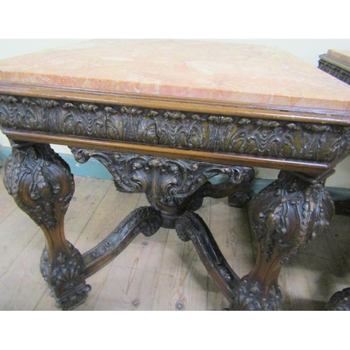 553 - A pair of 19c Continental marble top low tables on carved wood and stucco decorated frames, each wit... 