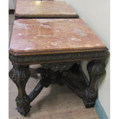 553 - A pair of 19c Continental marble top low tables on carved wood and stucco decorated frames, each wit... 