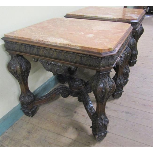 553 - A pair of 19c Continental marble top low tables on carved wood and stucco decorated frames, each wit... 