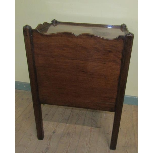 556 - A George III mahogany tray top bedroom commode with a cupboard enclosed by a hinged lift up door ove... 