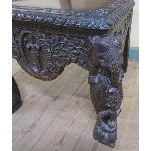 561 - A 19c Indian side chair with a figurative carved back panel within profuse leaf and flower under a s... 