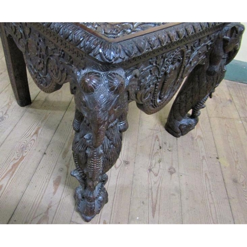 561 - A 19c Indian side chair with a figurative carved back panel within profuse leaf and flower under a s... 