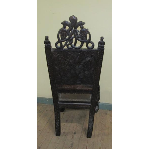 561 - A 19c Indian side chair with a figurative carved back panel within profuse leaf and flower under a s... 