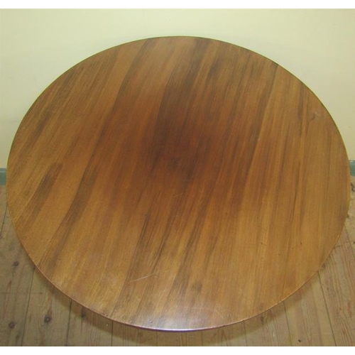 565 - An art nouveau mahogany circular two tier table with circular straight twin column supports having s... 