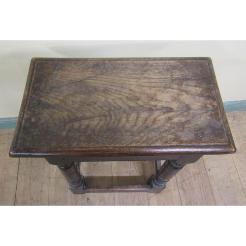 611 - An oak joint stool of rectangular form with moulded edge with baluster ring turned legs on block car... 