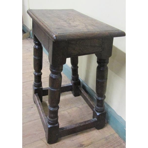 611 - An oak joint stool of rectangular form with moulded edge with baluster ring turned legs on block car... 