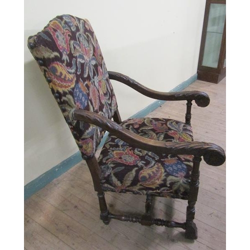 618 - A 19c walnut framed and upholstered open arm chair with bold leaf carved down swept arms, floral car... 