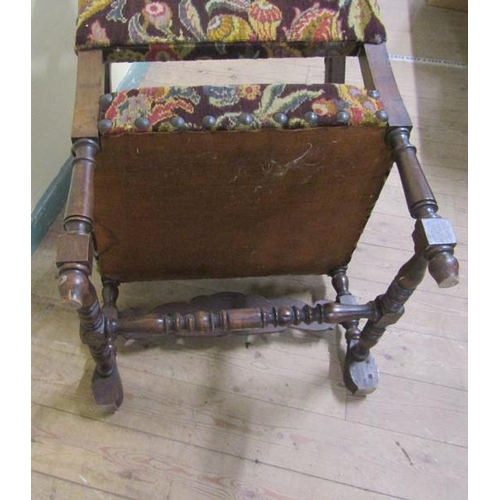 618 - A 19c walnut framed and upholstered open arm chair with bold leaf carved down swept arms, floral car... 